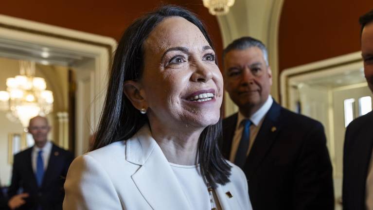 La líder opositora venezolana, María Corina Machado, saluda a senadores estadounidenses.