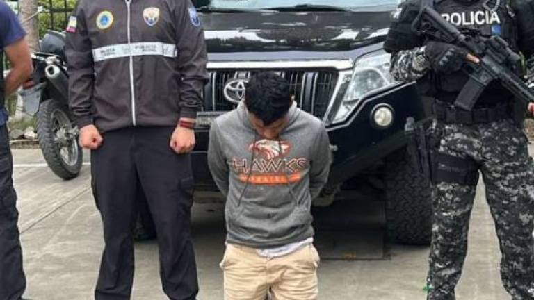 Fotografía que muestra al individuo bajo custodia policial.