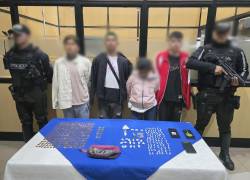 Fotografía que muestra a cuatro detenidos en el marco de la operación Apolo 19, realizada en Quito.