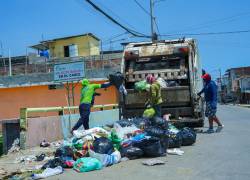 Fotografía que muestra a trabajadores municipales recolectando basura en la ciudad portuaria.