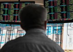 An investor monitors stock price movements at a securities company in Shanghai on September 24, 2021. (Photo by Hector RETAMAL / AFP)