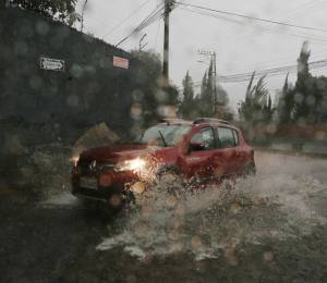 Fotografía referencial que muestra un auto atravesando un tramo inundado en la ciudad de Quito.