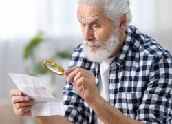 Adulto mayor revisando documentos.