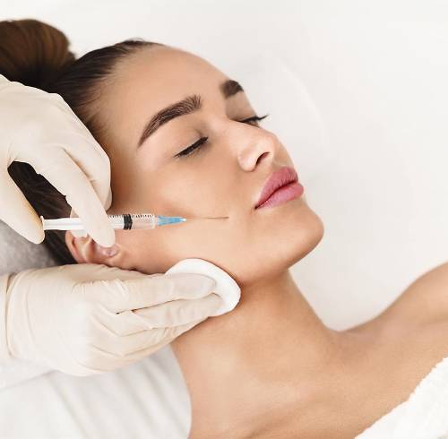 Mujer joven recibiendo una inyección de bótox en una clínica.