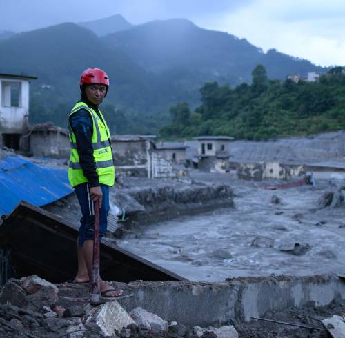 Un miembro de los equipos de rescate observa el lugar donde se encuentran edificios dañados tras las inundaciones repentinas en Trishuli Bazar, en el distrito nepalí de Nuwakot, el 29 de agosto de 2026.