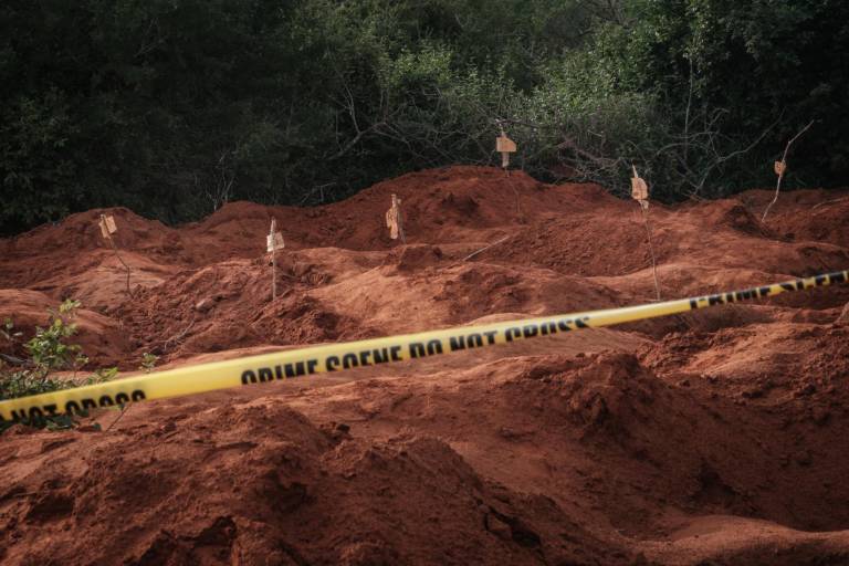 $!Se ven agujeros cavados después de exhumar cuerpos en la fosa común en Shakahola, en las afueras de la ciudad costera de Malindi, el 25 de abril de 2023.