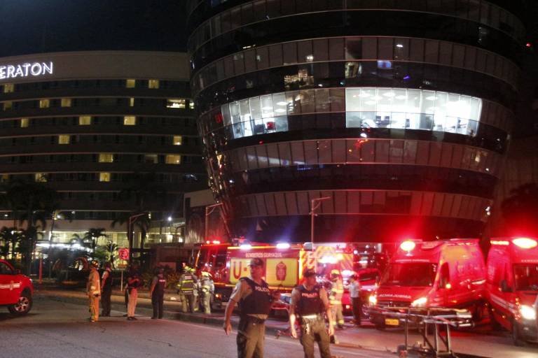 $!Agentes de policía y bomberos observan en la escena del crimen donde un presunto coche bomba explotó, en la Av. Joaqun Orrantia, en Guayaquil.