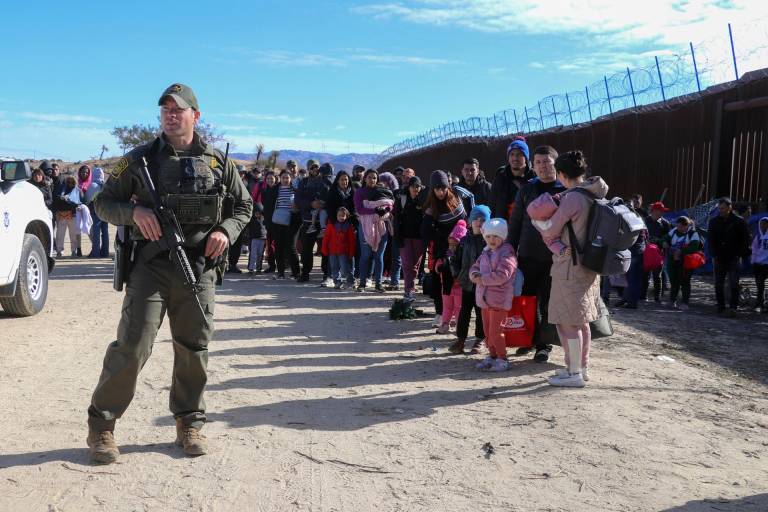$!Fotografía de archivo fechada el 29 de noviembre de 2023 que muestra a un agente de la Patrulla Fronteriza mientras vigila a un grupo de migrantes en el puesto fronterizo de Jacumba, a unas 75 millas (120 kilómetros) al este de San Diego, California (EEUU).