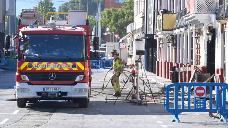 Un bombero sostiene tuberías frente a una discoteca un día después de un incendio que mató al menos a trece personas en una discoteca de Murcia, el 2 de octubre de 2023.