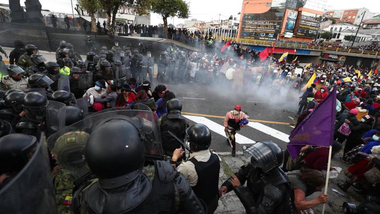 Policías dispersan a manifestantes que tratan de llegar a la sede de la Asamblea Nacional hoy, en Quito (Ecuador).