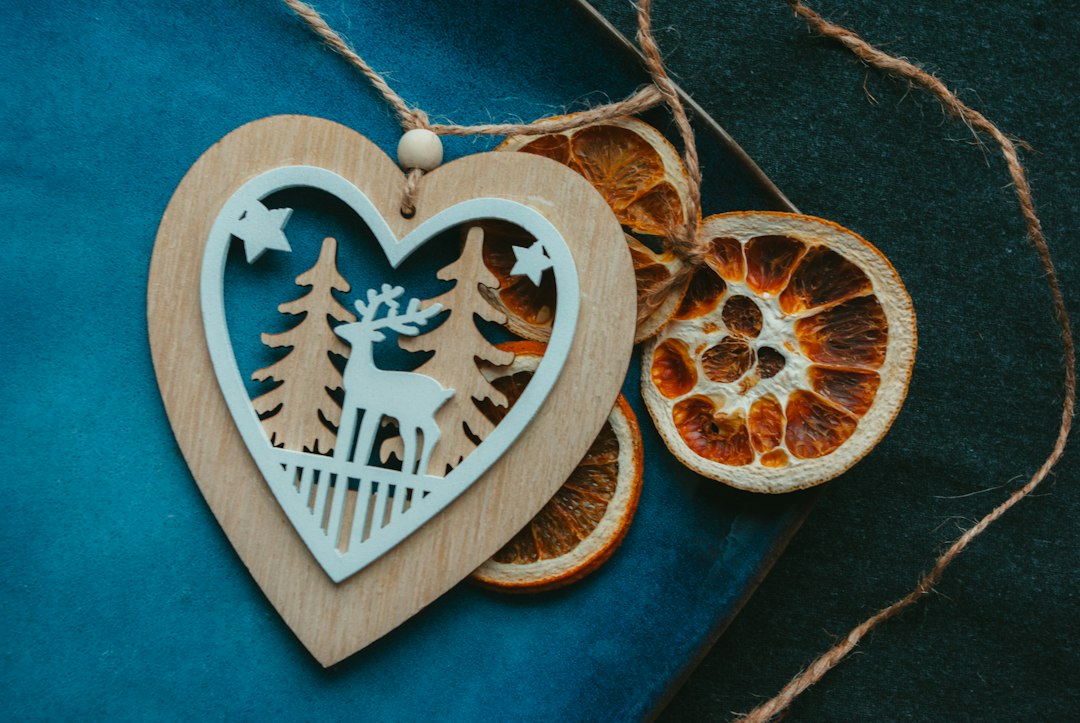 a wooden ornament with a deer and trees on it